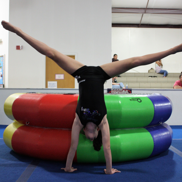 Girl in a straddle handstand
